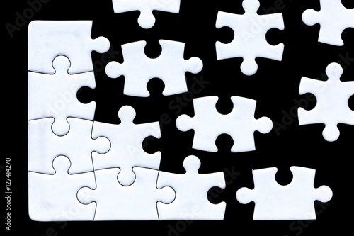 puzzle pieces coming together against a black background