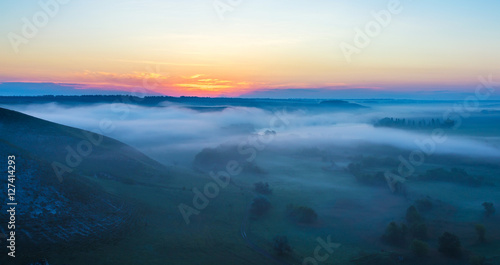 landscape of dense fog in the field at sunrise