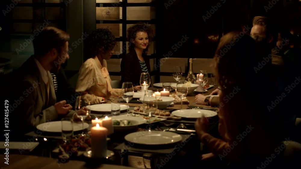 Multiethnic group of friends attending a dinner party.
Multiethnic group of friends attending a dinner party.