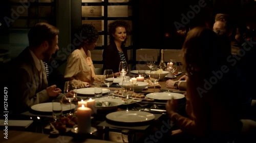 Multiethnic group of friends attending a dinner party. 
