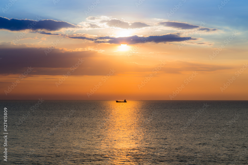 Boat in the ocean with sunset sky background, natural landscape background
