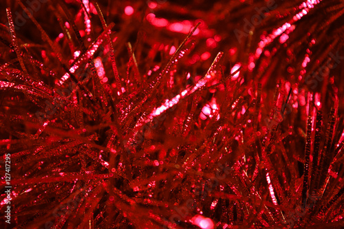 Background of red tinsel close-up. photo