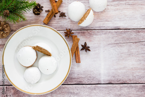 Fotografija Gingerbread cookies with icing sugar on wooden table, top view