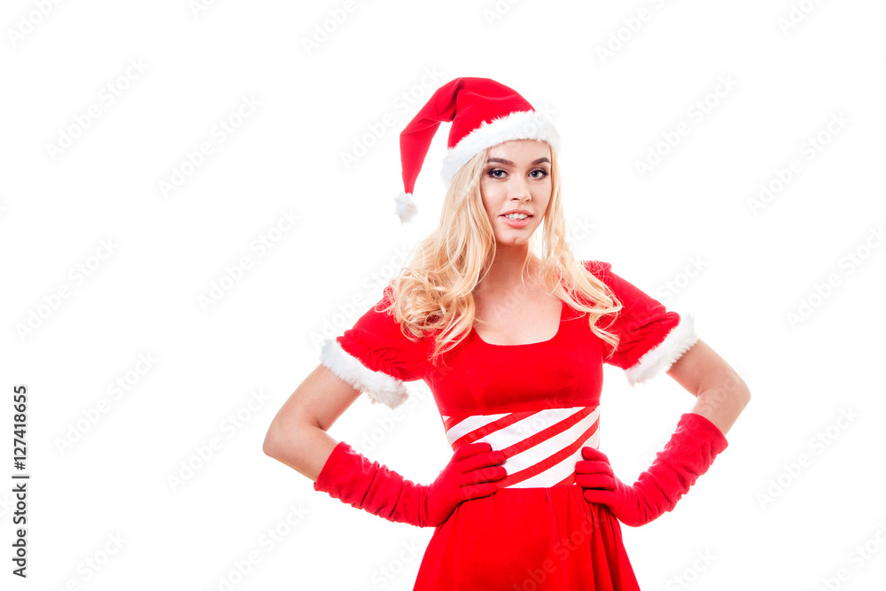 Beautiful blonde woman in dress and Santa's hat standing on the white background Beautiful blonde woman in dress and Santa's hat standing on the white background