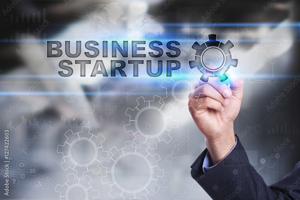 Businessman is drawing on virtual screen. business startup concept Businessman is drawing on virtual screen. business startup concept