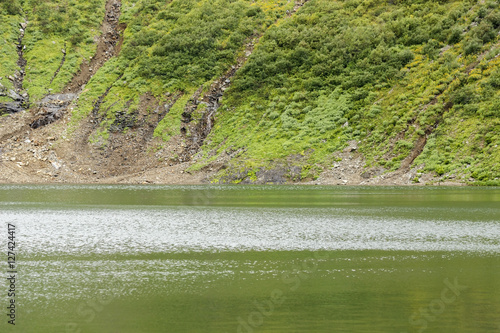 Russia. Khakassia. Sayan Mountains. Reserve Kuznetsky Alatau. Icy mountain lake, originating water from Snowfield.