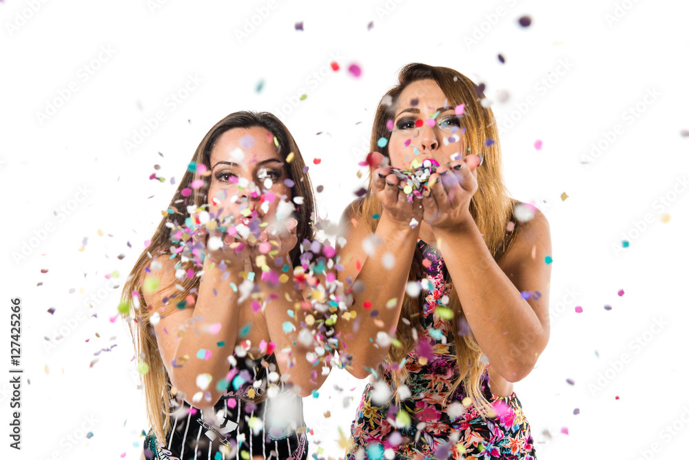 Happy young girls with confetti in a party - obrazy, fototapety, plakaty 