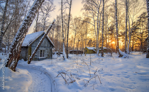 Obraz na płótnie abandoned cabin in winter sunset in forest w salonie