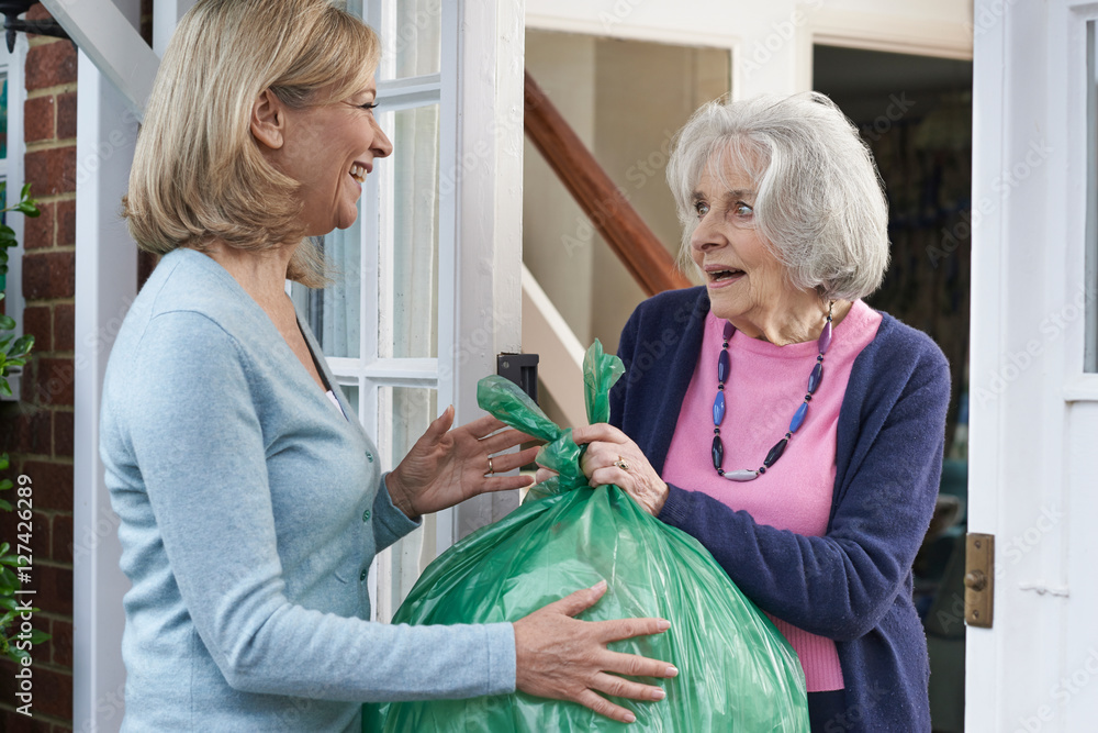 Obraz premium Woman Taking Out Trash For Elderly Neighbour