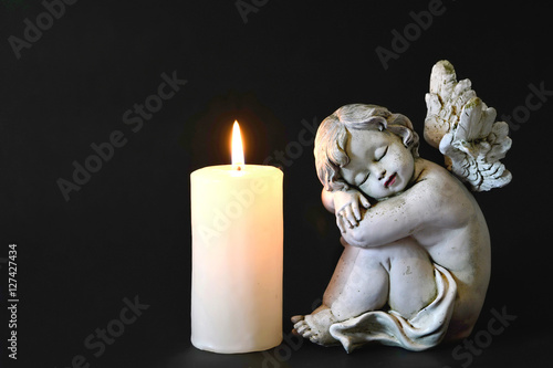 Candle and angel figurine