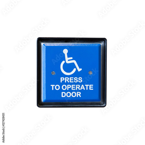 Handicapped access entrance pad on a wall.