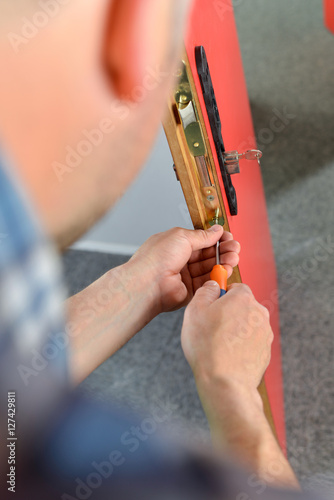 Locksmith repairing a lock photo