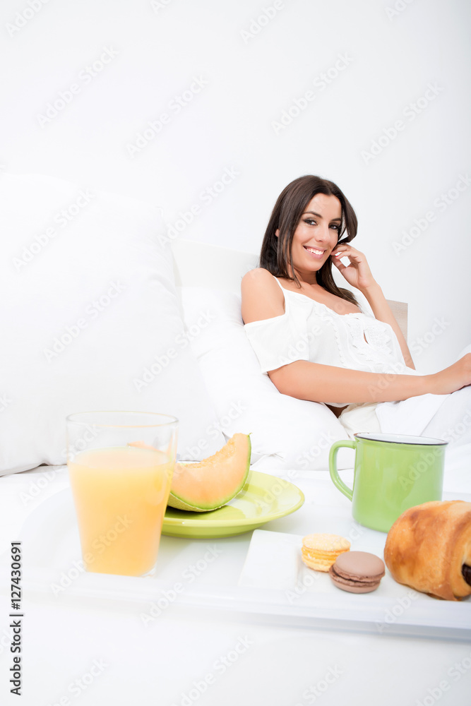 A beautiful young woman having breakfast in bed A beautiful young woman having breakfast in bed