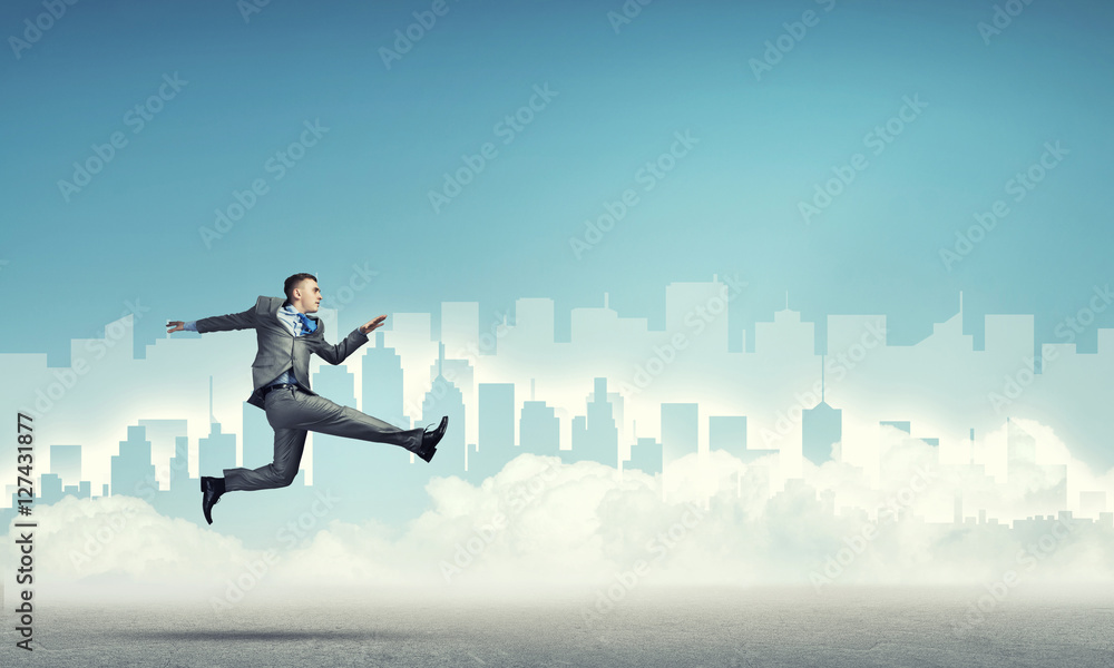 Businessman jumping high