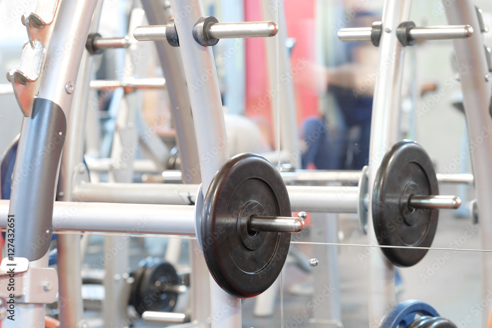 The image of barbells in a fitness hall