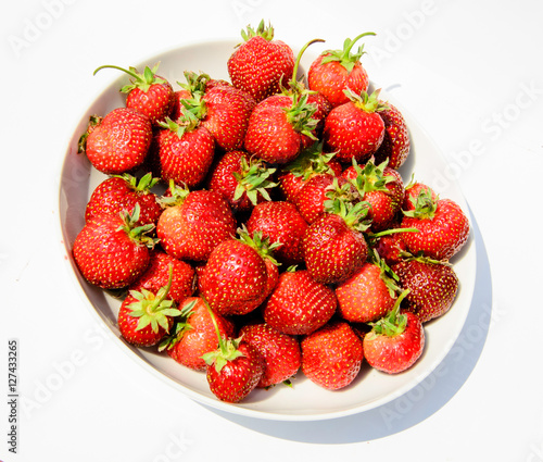 delicious  so sweet and juicy strawberries on a white plate