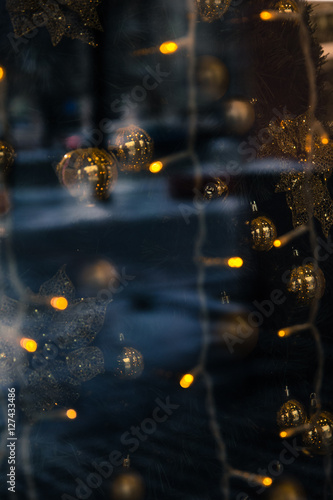 the reflection in the window Christmas lights, toys and people as a background, base, bright and festive. Vague and abstract © byallasaa