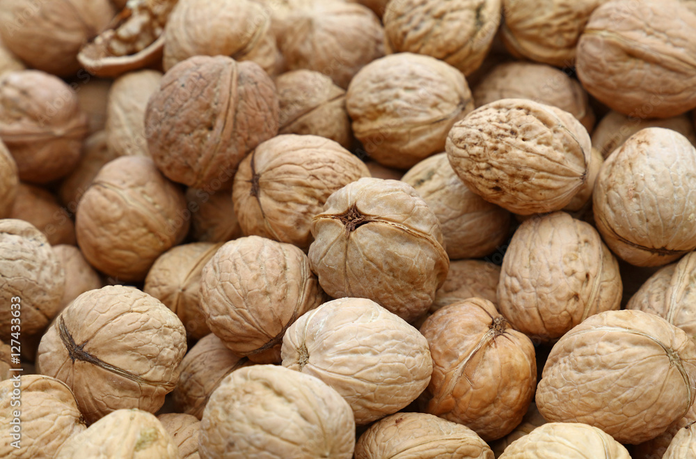 Whole walnuts in nutshells close up Whole walnuts in nutshells close up