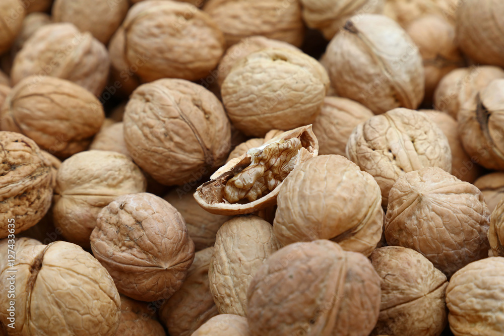 Whole walnuts in nutshells close up