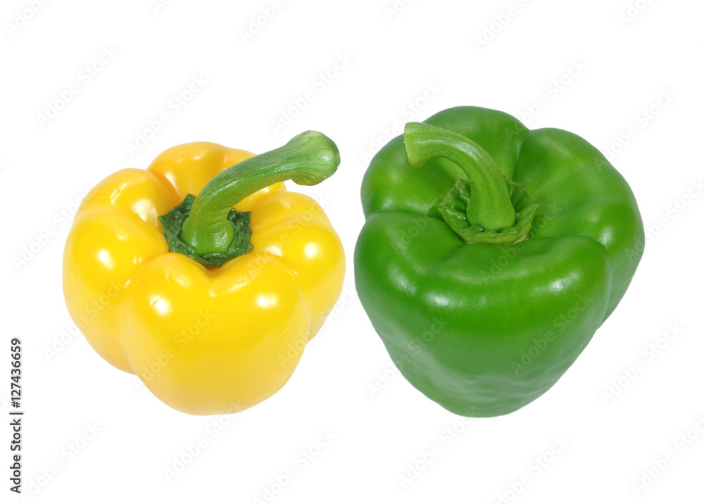 Closed up two ripe vibrant color bell peppers, one yellow and one green with stem, isolated on white background Closed up two ripe vibrant color bell peppers, one yellow and one green with stem, isolated on white background