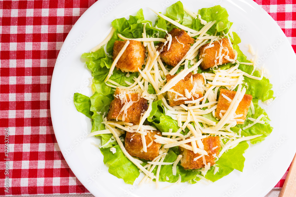 Caesar salad with croutons on a white plate Caesar salad with croutons on a white plate