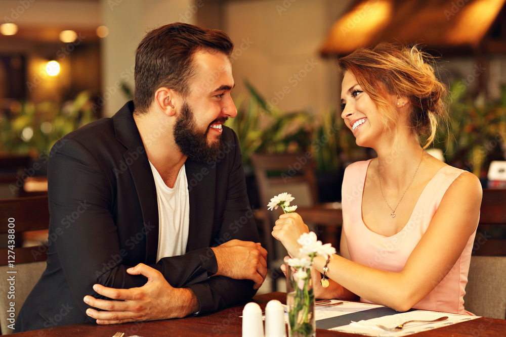 © Kalim - Romantic couple dating in restaurant