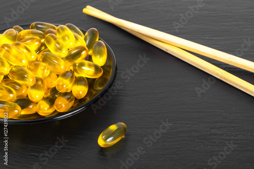 Fish oil supplements in soft gel capsule, healthy product concep photo