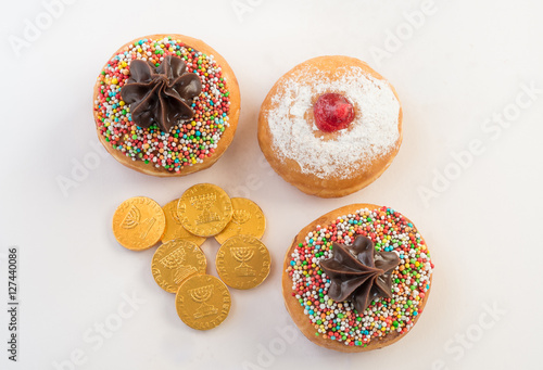 Fresh donuts and chocolate coins for Hanukkah celebration. 