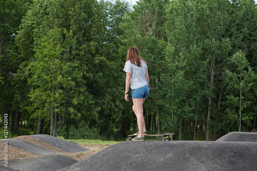 Girl practicing long board riding in skateboarding park © sociopat_empat