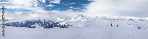 Ski slopes and skiers skiing in Kitzb  hel ski resort in Tyrolian Alps  Austria