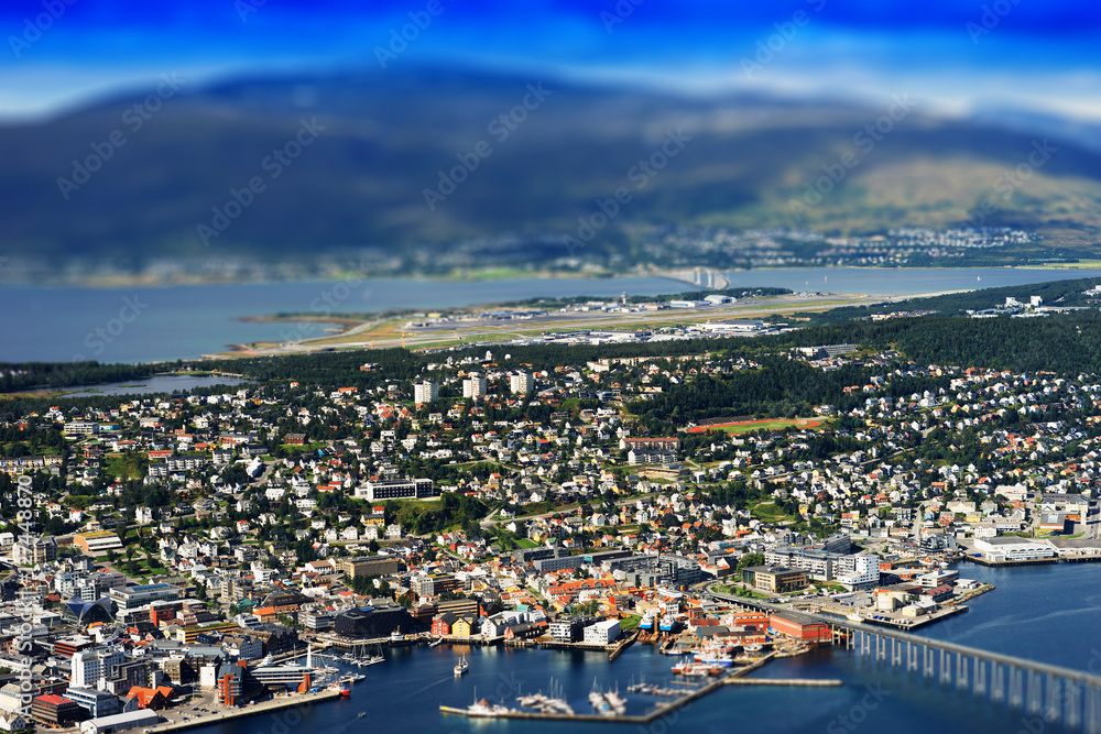 Tilt-shifted micro toy Tromso city with bridge background