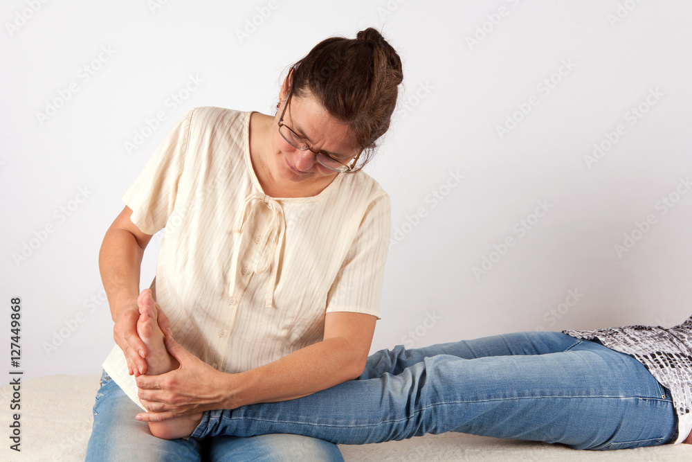 Bowen therapist giving leg massage treatment to a woman Bowen therapist giving leg massage treatment to a woman