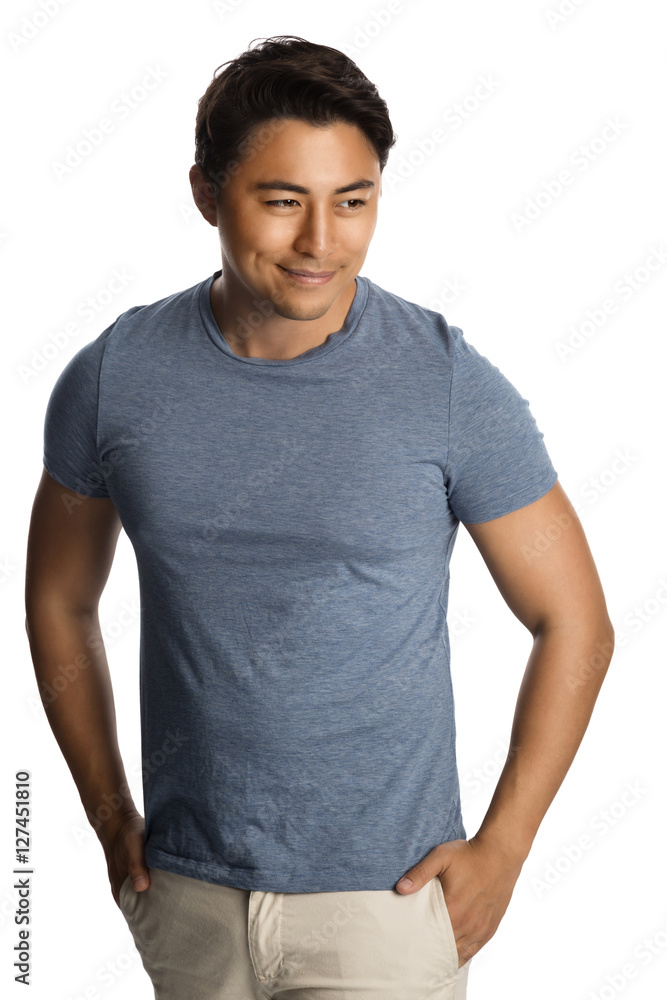 Handsome relaxed man wearing a tshirt and pants standing against a white background, relaxed looking. Handsome relaxed man wearing a tshirt and pants standing against a white background, relaxed looking.
