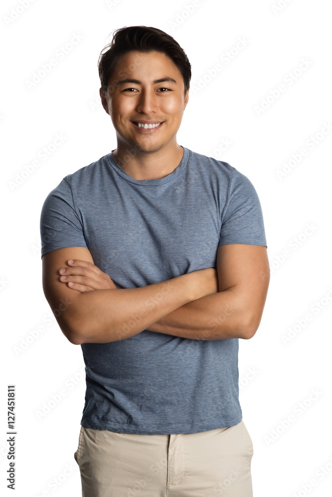 Obraz premium Handsome relaxed man wearing a tshirt and pants standing against a white background, relaxed looking.