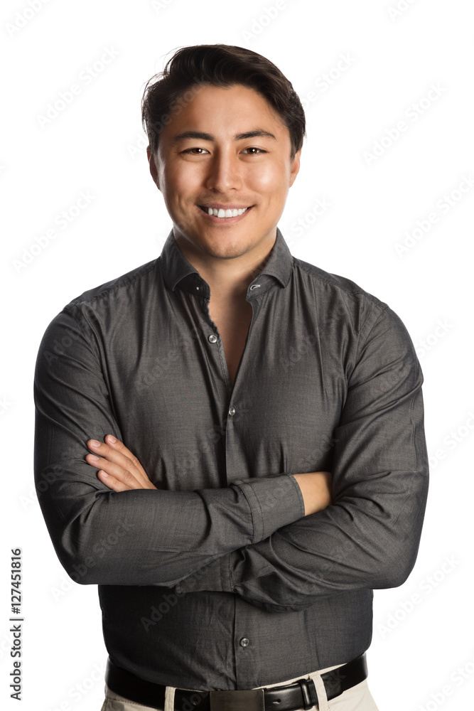 A trendy good looking man wearing a grey shirt standing against a white background relaxing. A trendy good looking man wearing a grey shirt standing against a white background relaxing.