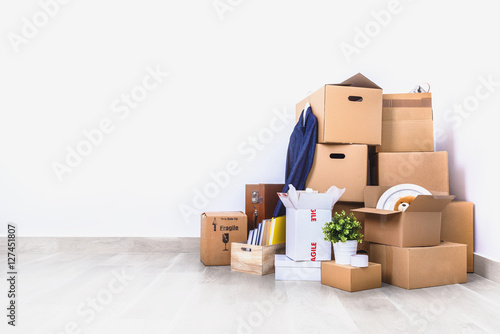 Move. Cardboard boxes in empty room corner. photo