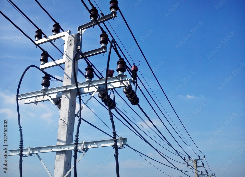 Electric pole connect to the high voltage electric wires on blue sky background