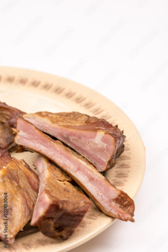 Raw smoked ribs on the plate over white background