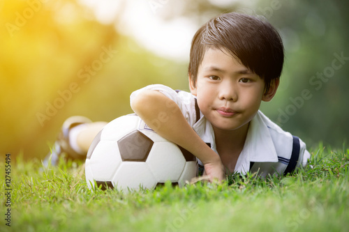 Little asian boy with football at the park © sirikorn