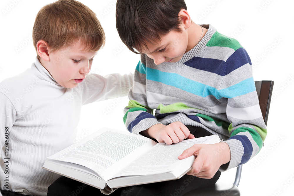 Two boys reading big book