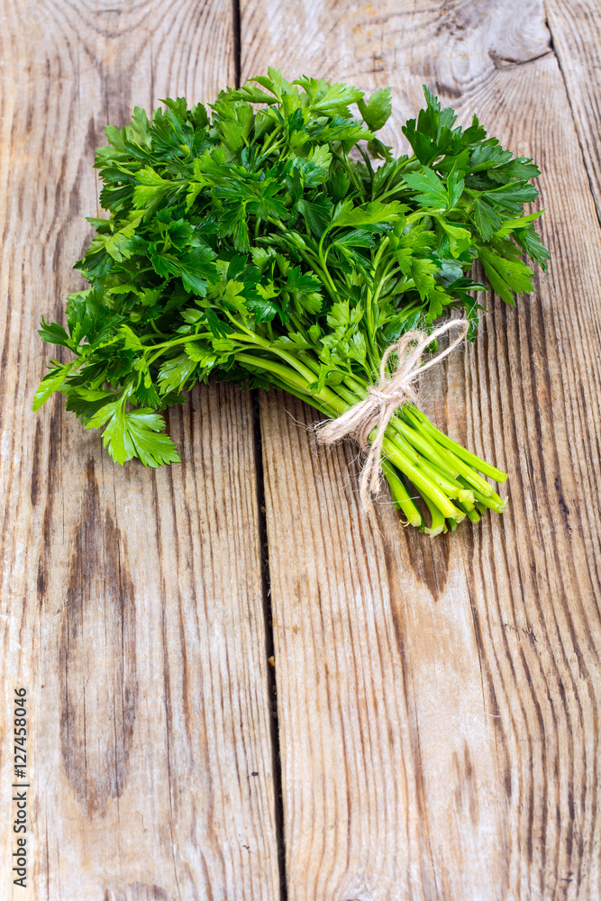 Fresh green bunch of parsley on the old board Fresh green bunch of parsley on the old board