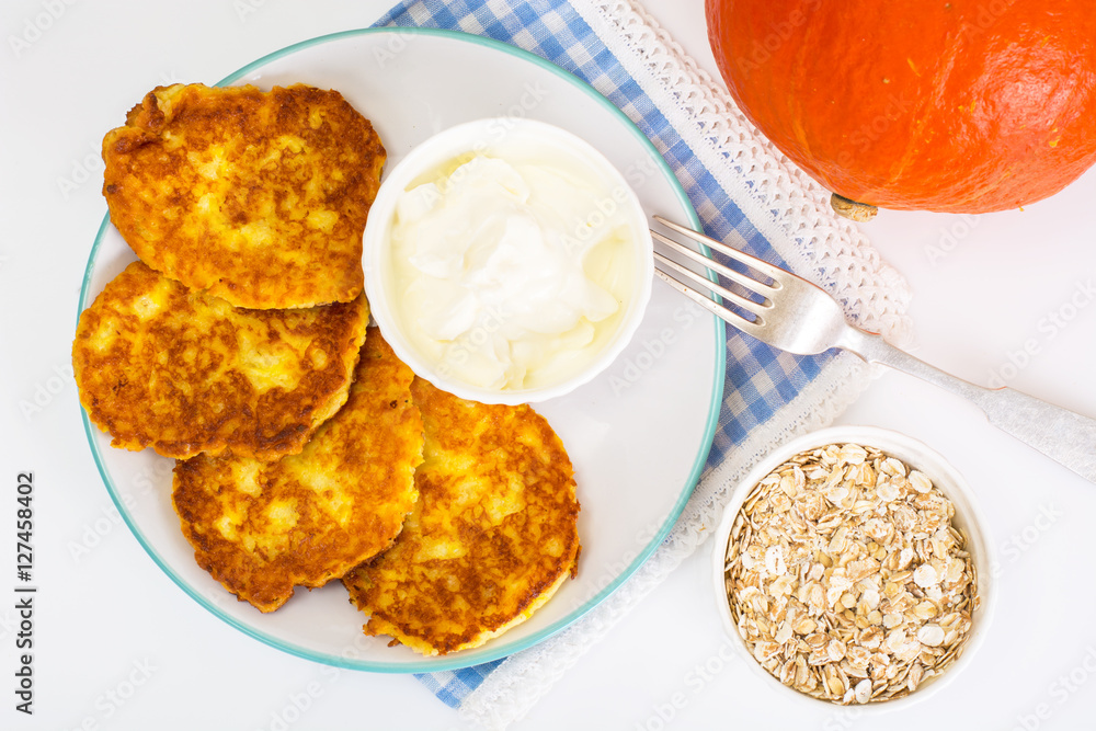 Pumpkin-oatmeal pancakes with curry on a white background Pumpkin-oatmeal pancakes with curry on a white background