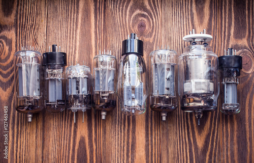 electronic vacuum tubes on the wooden background. closeup view.
