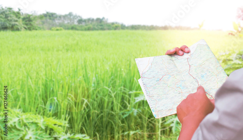 Man reading map in garden.