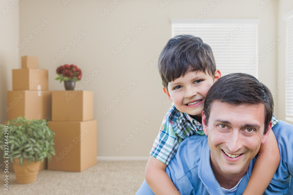 Happy Father and Son in Room with Packed Moving Boxes and Potted Plants. Happy Father and Son in Room with Packed Moving Boxes and Potted Plants.