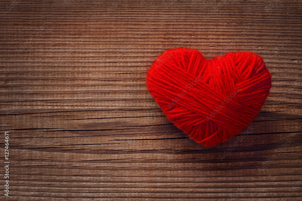 Beautiful red heart of wool yarn on rustic background. Love and St. Valentines Day concept. Close up. Copy space. High resolution product Beautiful red heart of wool yarn on rustic background. Love and St. Valentines Day concept. Close up. Copy space. High resolution product