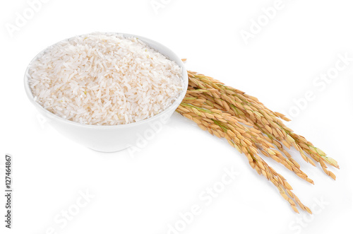 white rice on the wooden plate and rice plant , uncooked raw cer