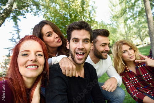 Group of friends taking selfie in urban background