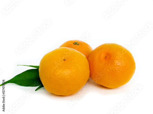 Tangerines with leaves and slices on white background