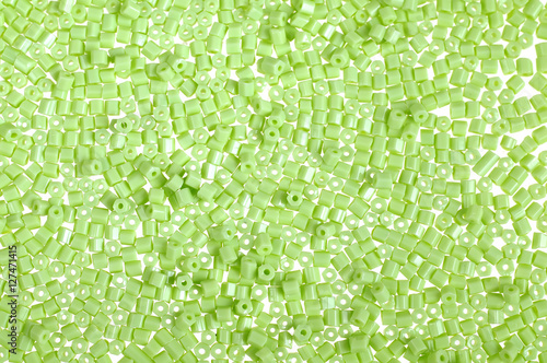 Green glass beads background - closeup beads texture